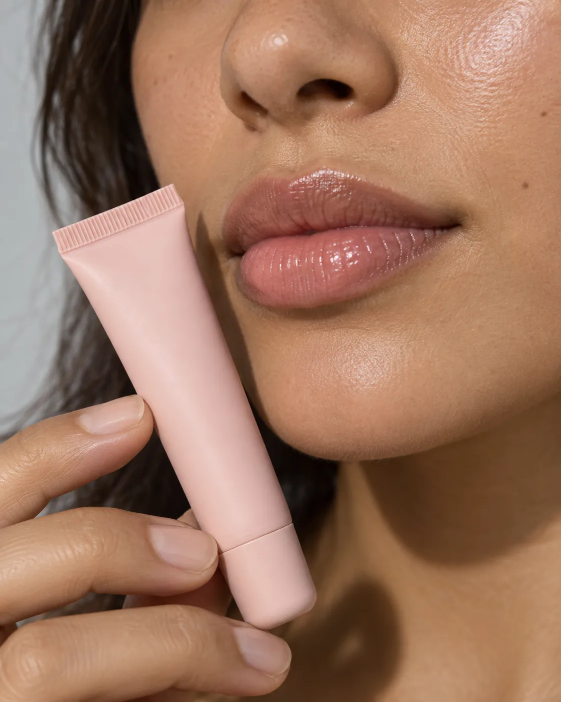 Pink lips with the soft lip tube held beside them